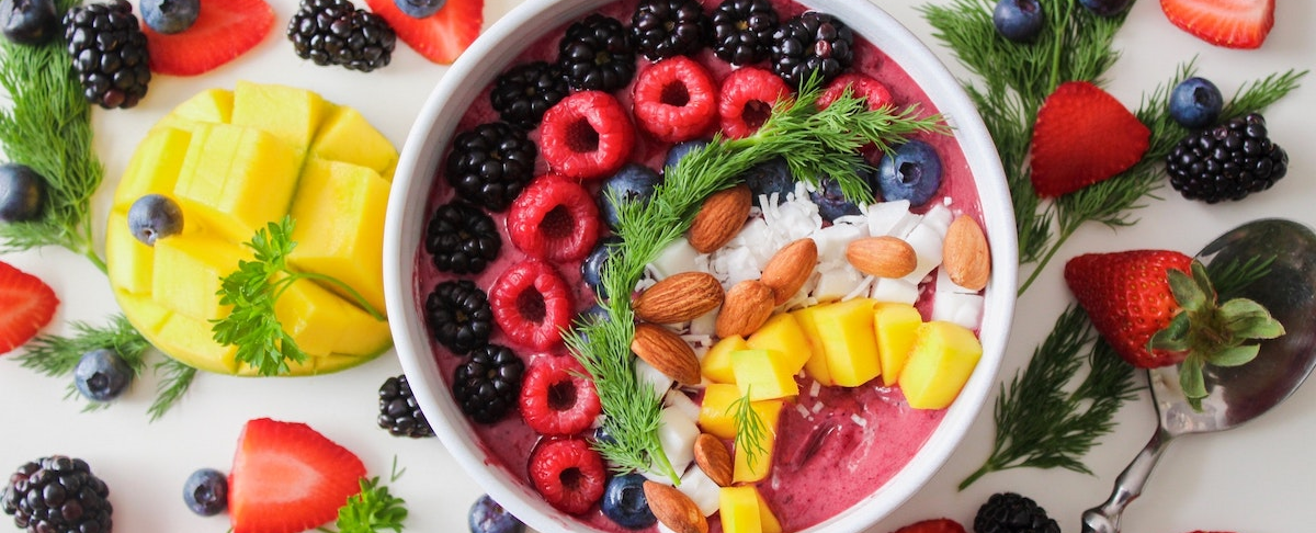 photo of fruit in and surrounding bowl
