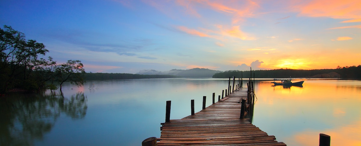 photo of dock sunset and boat